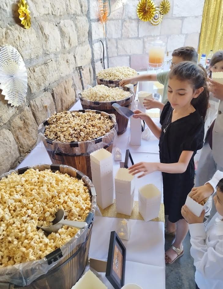 Guests enjoying a popcorn bar at a Bat Mitzvah celebration