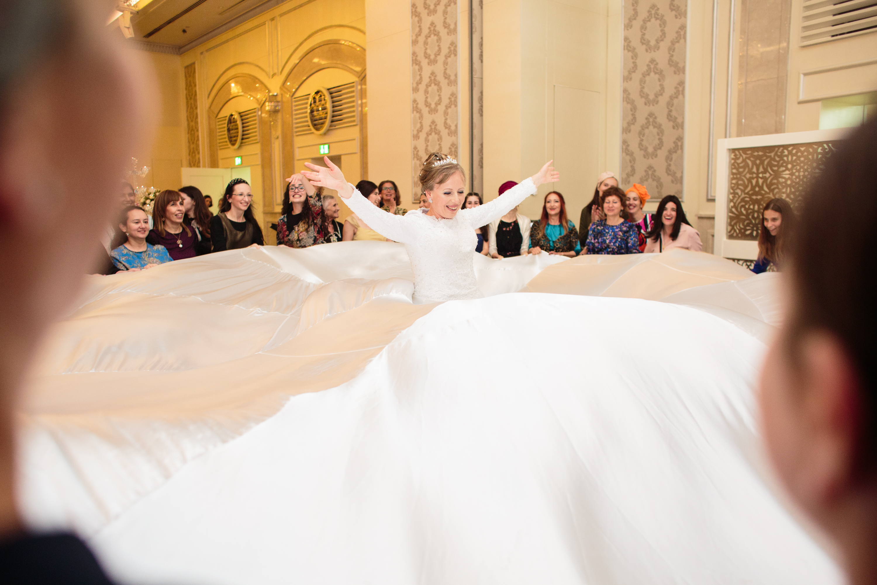 The bride spinning with her skirt flared around her at Hannah and Sol Levy’s wedding