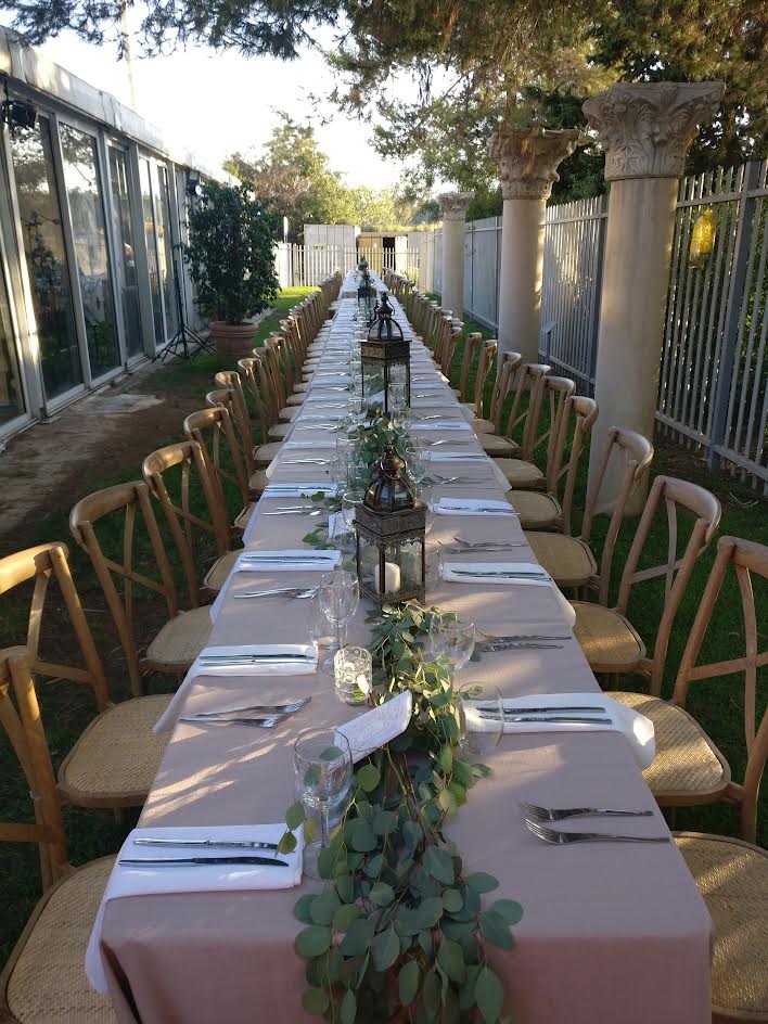 An outdoor banquet beside classical stone columns
