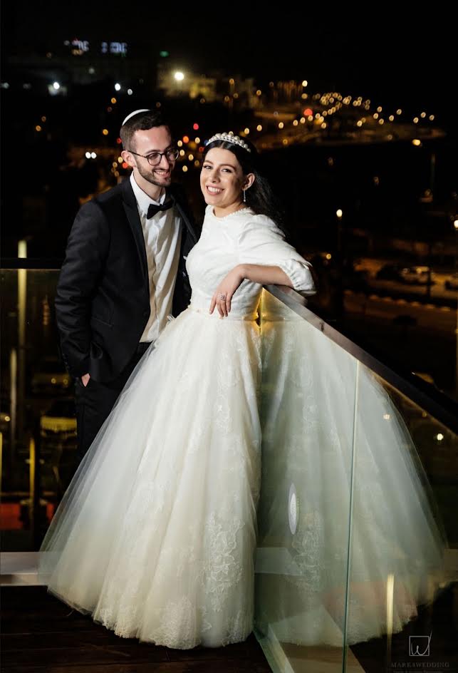 Newlyweds on a balcony at night