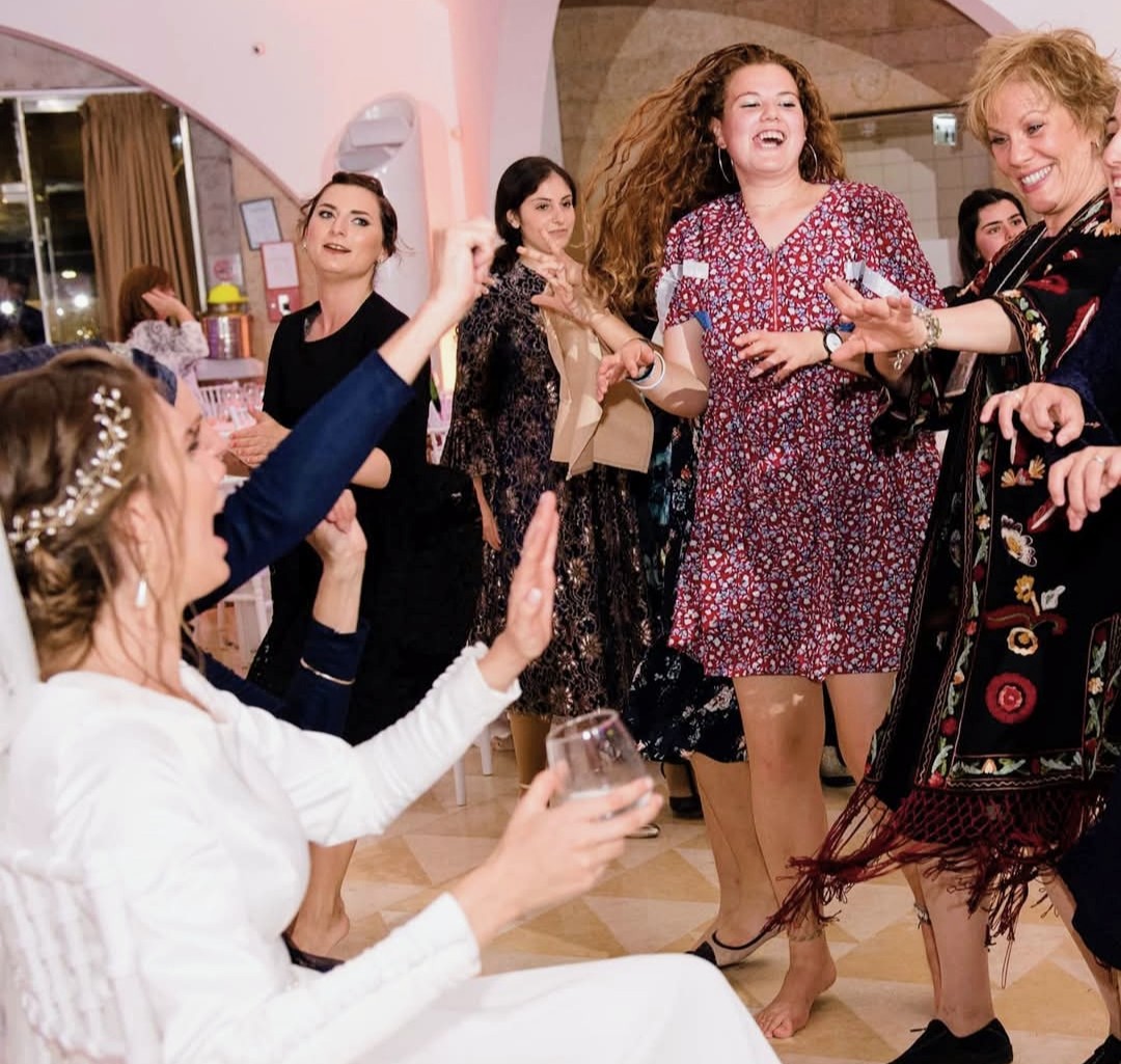 Risa dancing with guests at a wedding celebration