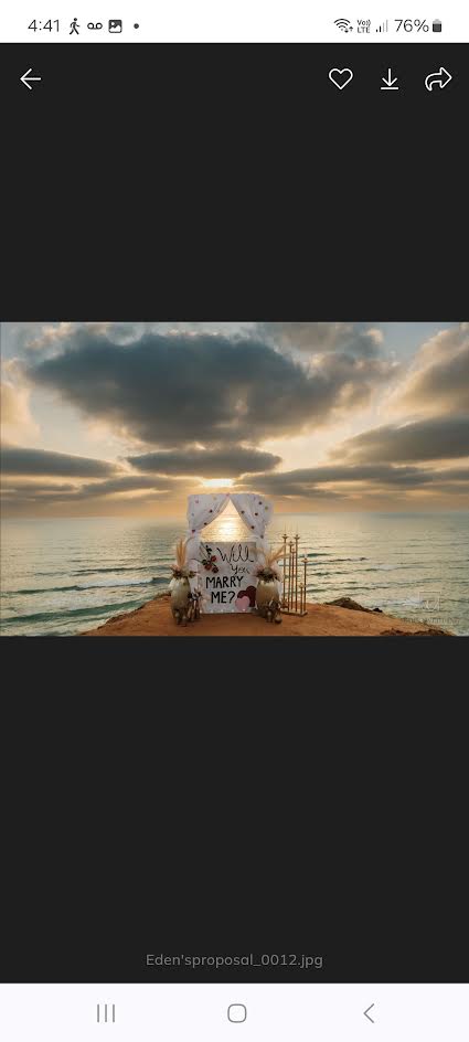 A Will you marry me proposal setting overlooking the sea at sunset